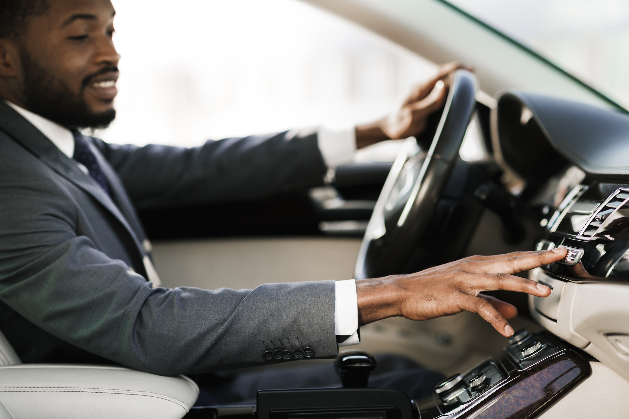 Relaxed Black Man Driving Car Listening Radio Sitting In Automobile
